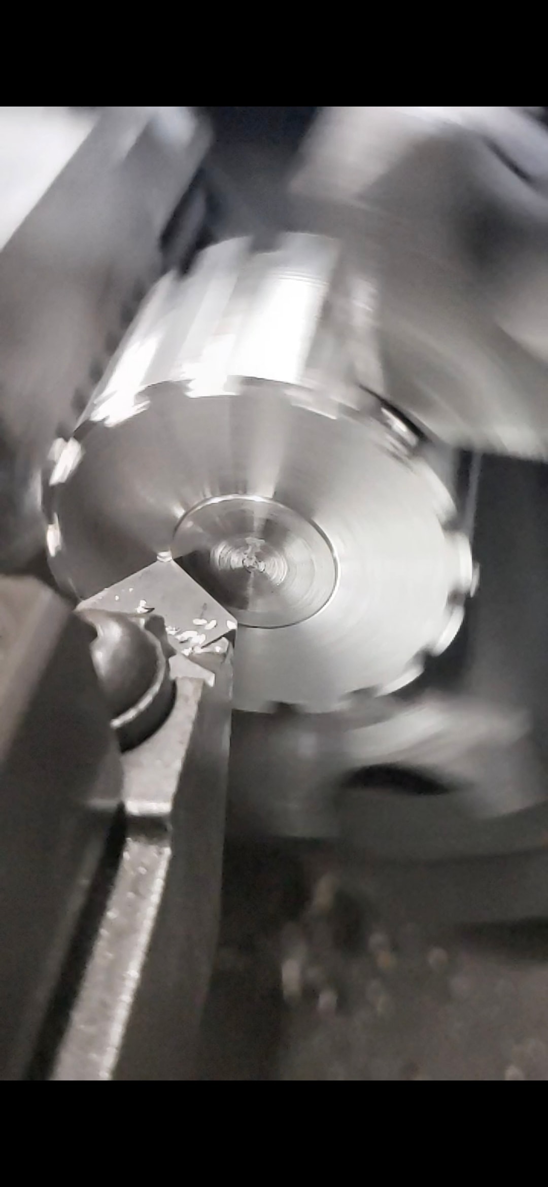 Metal lathe turning precision component in action